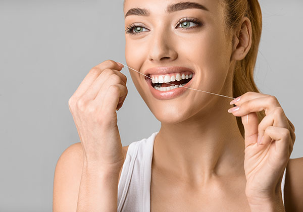 tooth-care-young-woman-using-dental-floss